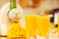 Making orange juice in juicer machine in kitchen Royalty Free Stock Photo