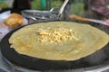 Making pancake with filling on frying electric stove