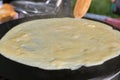 Making pancake with filling on frying electric stove