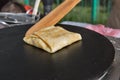 Making pancake with filling on frying electric stove