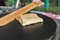 Making pancake with filling on frying electric stove