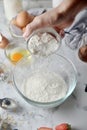 Making pancakes, cake, baking of baker hands pouring flour in bowl. Concept of Cooking ingredients and method on white marble Royalty Free Stock Photo