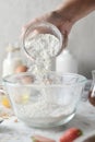 Making pancakes, cake, baking of baker hands pouring flour in bowl. Concept of Cooking ingredients and method on white marble Royalty Free Stock Photo