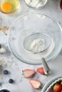 Making pancakes, cake, baking of baker hands sifting flour in bowl. Concept of Cooking ingredients and method on white marble Royalty Free Stock Photo