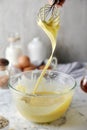 Making pancakes, cake, baking side view of baker hands pouring batter and whisking batter in bowl. Concept of Cooking ingredients Royalty Free Stock Photo