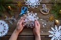 Making paper snowflakes with your own hands. Children& x27;s DIY. Merry Christmas and New Year concept. Step 3. Open the snowflake