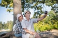 Couple of beaming mature adults making photo together