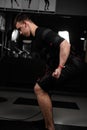 Making physical exercises using EMS suit in gym. Sport training in electrical muscle stimulation suit Royalty Free Stock Photo