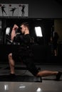 Making physical exercises using EMS suit in gym. Sport training in electrical muscle stimulation suit Royalty Free Stock Photo