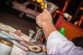 Making a picture of sand in a bottle. Male hands closeup. Hurghada, Egypt.