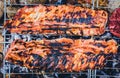 Making pork ribs on homemade improvised BBQ barbecue grill.