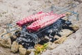 Making pork ribs on homemade improvised BBQ barbecue grill.