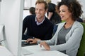 Making positive progress. Male and female coworkers working positively on a project together. Royalty Free Stock Photo