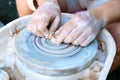 Making pottery on a potter`s wheel. Hands craftsman close-up, mold dishes. Master class