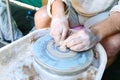 Making pottery on a potter`s wheel. Hands craftsman close-up, mold dishes. Master class Royalty Free Stock Photo