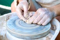 Making pottery on a potter`s wheel. Hands craftsman close-up, mold dishes. Master class