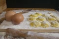 Making homemade Ravioli / Tortellini /dumpling with eggs on floured wood