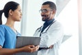 Making primary care a priority. two young doctors using a digital tablet in a modern hospital. Royalty Free Stock Photo