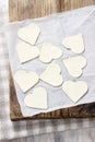 Making puff pastry cookies in heart shape filled with strawberries. Royalty Free Stock Photo