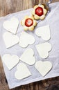 Making puff pastry cookies in heart shape filled with strawberries. Royalty Free Stock Photo