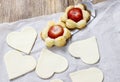 Making puff pastry cookies in heart shape filled with strawberries. Royalty Free Stock Photo