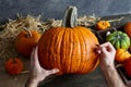 Making pumpkin jack-o-lantern for Halloween holiday