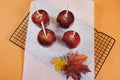 Making red toffee apples for Halloween trick or treat food candy Royalty Free Stock Photo