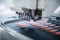 Making rocket pictures. Close up view of white automatic sewing machine at factory in action