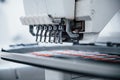Making rocket pictures. Close up view of white automatic sewing machine at factory in action
