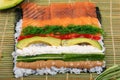 Making Rolled Sushi in a bamboo Sushi Mat Royalty Free Stock Photo