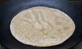 Making roti Indian Chapati on roti tawa made of wheat dough Royalty Free Stock Photo
