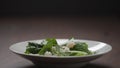 making salad shrimps fall over romaine leaves in white bowl Royalty Free Stock Photo