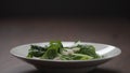 making salad shrimps fall over romaine leaves in white bowl Royalty Free Stock Photo