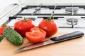 Making salad with tomato and cucumber in the kitchen.