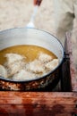 Samosa deep fried pastry snack in hot oil - Indian or African cuisine cooking