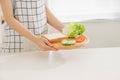 Making sandwich with bread, cheese, salad and ham with hands on wooden cutting board Royalty Free Stock Photo