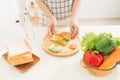 Making sandwich with bread, cheese, salad and ham with hands on wooden cutting board Royalty Free Stock Photo