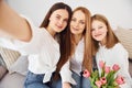 Making selfie. Young mother with her two daughters at home at daytime Royalty Free Stock Photo