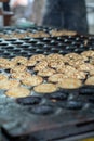Making small pancakes, traditional Dutch poffertjes on street ma