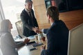 Making smart business moves. two businessmen shaking hands during a meeting in the boardroom. Royalty Free Stock Photo