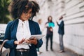 Making smart moves on the go. a businesswoman holding a digital tablet while walking through the city.