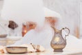 Making soap foam for massage. Water jar, towel and copper bowl w