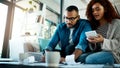 Making some calculations to secure the best for their finances. a young couple planning their budget together at home.