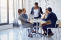 Making sound business decisions. a team of businesspeople working on a laptop together at a table in the office. Royalty Free Stock Photo