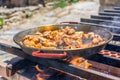 Making spanish traditional valencian Paella stir-frying Rabbit meat, Artichokes and Green Beans. Royalty Free Stock Photo