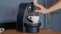 Making specialty compostable capsule coffee with Nespresso coffee machine. High-quality jpg image. Royalty Free Stock Photo