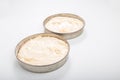 Making sponge cake, 2 cake in tins with cake batter ovenready Royalty Free Stock Photo
