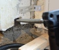 Making a square hole in a concrete wall using a punch tool and a chisel attachment Royalty Free Stock Photo