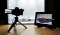 Making a studio shot using a light box. Camera on tripod, tablet set on camera remote control Royalty Free Stock Photo