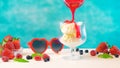 Making summertime gourmet berry and vanilla ice cream sundae. Royalty Free Stock Photo